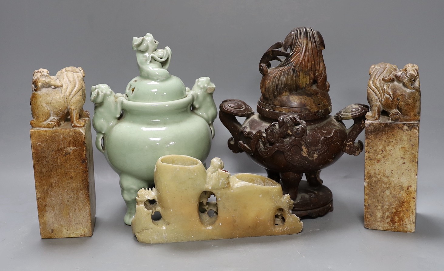 A Chinese celadon ground censer, together with a hardstone censer, a soapstone carving and two hardstone seals. Tallest 22cm